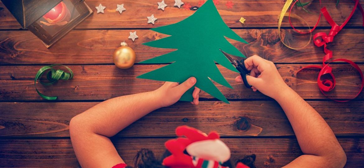 girl cutting out a christmas tree