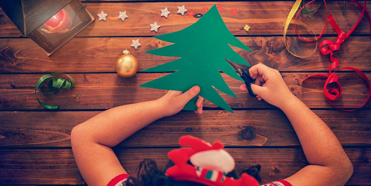 girl cutting out a christmas tree